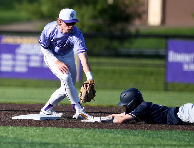Hoban's Will Givens slides past the tag of Kyle Andrews in the 3rd inning of Hoban at Jackson baseball. Thursday, April 18, 2024.